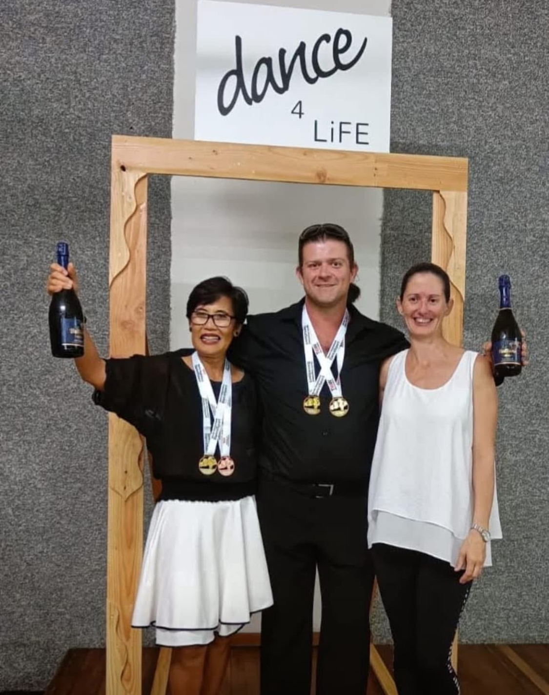 dance4Life FNQ competition winners with medals and champagne